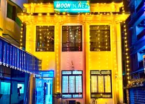 a building with a street sign on top of it at Hotel Moon N' Net in Digha