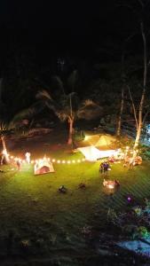 a group of tents in a field at night at Segar Farm and Campground in Biga-an