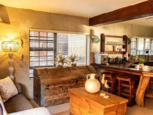 a living room with a wooden table and a counter at East River @ 21 in Kleinemonde +34 photos