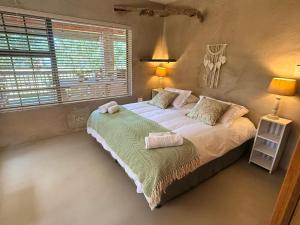 a bedroom with a bed with two towels on it at East River @ 21 in Kleinemonde