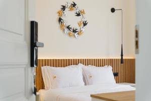 a bedroom with a bed with a wreath on the wall at Kismet Urban Boutique in Heraklio