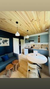 a living room with a table and a couch at La maisonnette au bord de l eau in Grimaucourt-près-Sampigny