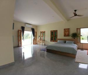 a bedroom with a bed and a ceiling fan at Half Way Villa in Luang Prabang