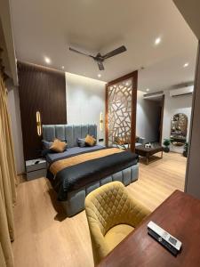 a bedroom with a large bed and a table at Galaxy Blue Sapphire Studio in Ghaziabad