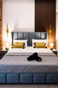 a bedroom with a large bed with a hat on it at Galaxy Blue Sapphire Studio in Ghaziabad