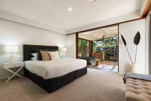 a bedroom with a large bed and a sliding glass door at Glenbrook House and Studio in Ewingsdale +48 photos
