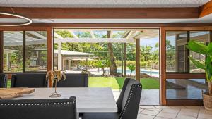 an outdoor dining room with a table and chairs and a patio at Glenbrook House and Studio in Ewingsdale