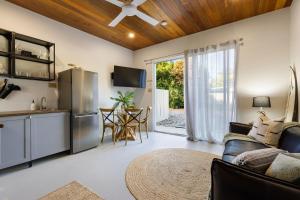 a kitchen and living room with a couch and a refrigerator at Glenbrook House and Studio in Ewingsdale