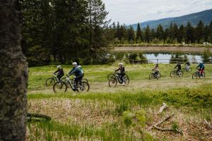 a group of people riding bikes in a field at Hotel Panorama Kope in Šmartno pri Slovenj Gradcu