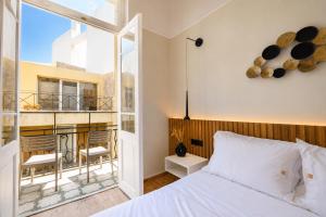 a bedroom with a bed and a balcony at Kismet Urban Boutique in Heraklio