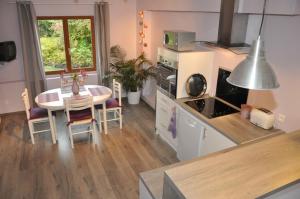 a kitchen and dining room with a table and a table and chairs at Gîte G4122 in Quincampoix +13 photos