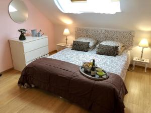 a bedroom with a bed with a tray of food on it at Gîte G4122 in Quincampoix