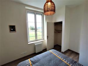 a bedroom with a bed and a window at Gîte G4144 in Saint-Pierre-de-Varengeville