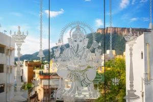 a glass window with a statue of a deity at SRL Grand Residency in Tirupati