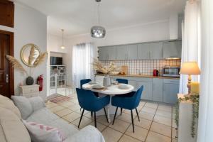 a kitchen and living room with a table and chairs at Paxos Center in Gaios