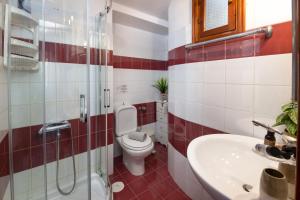 a bathroom with a toilet and a sink at Paxos Center in Gaios +8 photos
