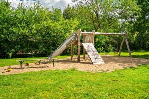 a playground with a slide in a park at Hotel Bolter Mühle - DZ Gerstenkammer in Rechlin