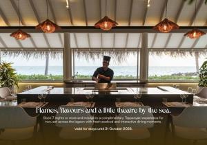 a man standing behind a table in a restaurant at Sun Siyam Iru Veli - 24 Hours Premium All Inclusive Dine Around with Free Sea Plane Transfers & Exclusive Inclusions in Dhaalu Atoll