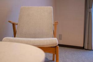 a chair sitting in a room next to a table at The ISA Hotel Tenjin Fukuoka in Fukuoka