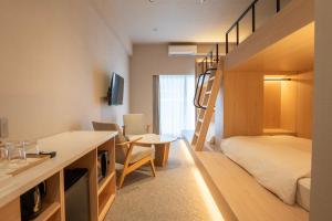 a small room with a bunk bed and a desk at The ISA Hotel Tenjin Fukuoka in Fukuoka +24 photos