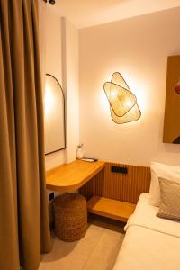 a bedroom with a desk with a mirror and a bed at Kotraba Alacati Hotel in Alaçatı