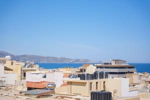 a group of buildings with the ocean in the background at Kismet Urban Boutique in Heraklio