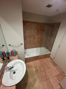 a bathroom with a sink and a shower at Viaduct Spacious 2 Bedroom Apartment in Auckland +12 photos
