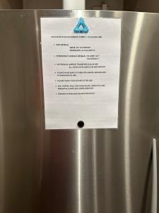 a sign on the side of a refrigerator at Viaduct Spacious 2 Bedroom Apartment in Auckland