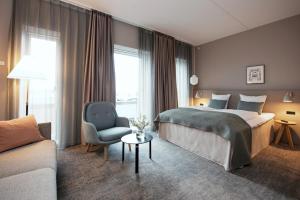 En eller flere senge i et værelse på Hotel Odeon