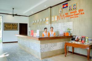 two people standing at a counter in a restaurant at Angkor Tempora Boutique in Siem Reap