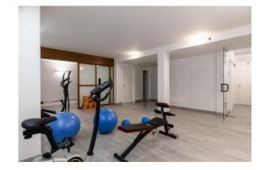 a gym with several exercise equipment in a room at Rifugio del Mare con piscina e palestra in Loano