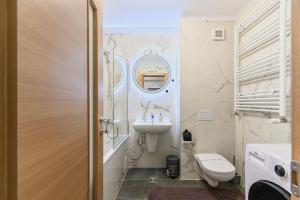 a bathroom with a sink and a toilet at MoHost Blue Moon Apartments in Braşov