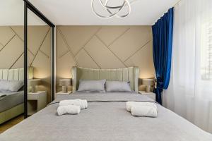 a bedroom with a large bed with two white pillows at MoHost Blue Moon Apartments in Braşov