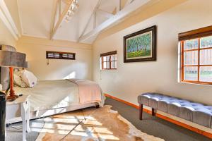 a bedroom with a bed and a couch at Cinzaco Dullstroom in Dullstroom