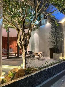 a tree in a courtyard with a building at HOA GIO Boutique stay in Hue