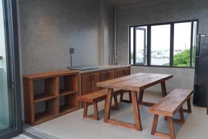a kitchen with wooden tables and benches and a window at HOA GIO Boutique stay in Hue +119 photos