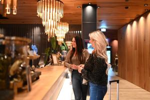 two women walking down a hallway in a store at Meiser Design Hotel in Dinkelsbühl +25 photos