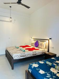 a bedroom with two beds in a room at Saffron Swell Villa in Arugam Bay