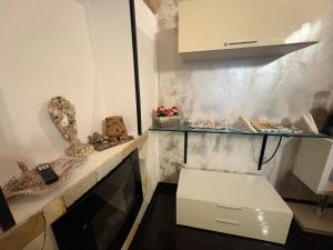 eine kleine Küche mit einer Theke mit einer weißen Box in der Unterkunft Lu bobò in Alghero + 38 Fotos