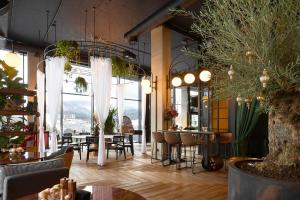 a restaurant with tables and chairs and large windows at Mountain Residence 4* in Bukovel