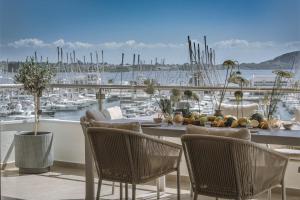 a balcony with a table and chairs and a harbor at Akari - Luxury Apartment in Preveza
