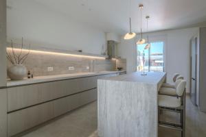 a kitchen with a marble counter in a room at Akari - Luxury Apartment in Preveza +28 photos