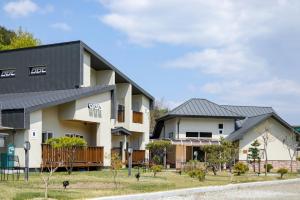 a large white building with a black roof at Samcheok Yonghwa Silkroad Pension in Samcheok