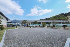 a parking lot in front of a building at Samcheok Yonghwa Silkroad Pension in Samcheok +30 photos