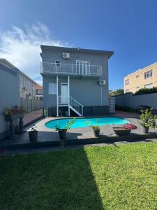 a house with a swimming pool in a yard at Premier Residence in Windermere in Durban +19 photos