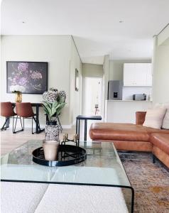 a living room with a couch and a table at Premier Residence in Windermere in Durban
