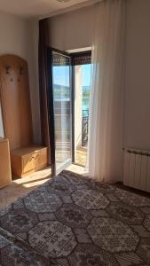 a room with a large bed and a large window at Lake Crown in Ogulin