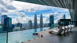 a pool on top of a building with a view of the city at Imperial KLCC Residences in Kuala Lumpur