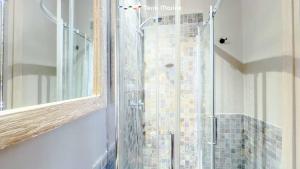 a glass shower in a bathroom with a mirror at Terre Marine Rooms in Riomaggiore +31 photos