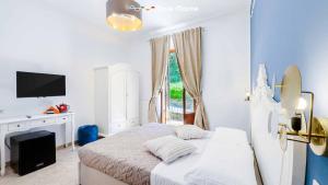 a white bedroom with a bed and a window at Terre Marine Rooms in Riomaggiore